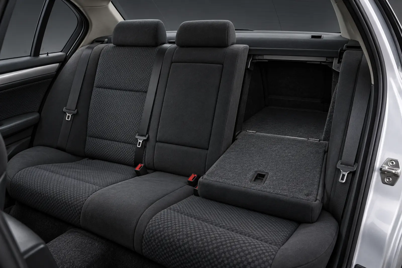 AI illustration of a car's rear bench in dark patterned cloth, seen through the open rear door, with the right part of the backrest folded forward and the boot visible behind it