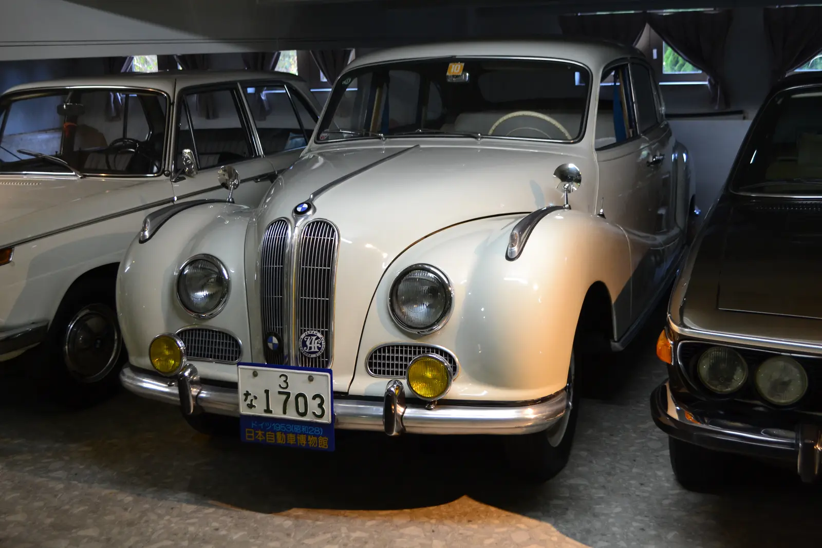 A white BMW 501 saloon in a museum hall